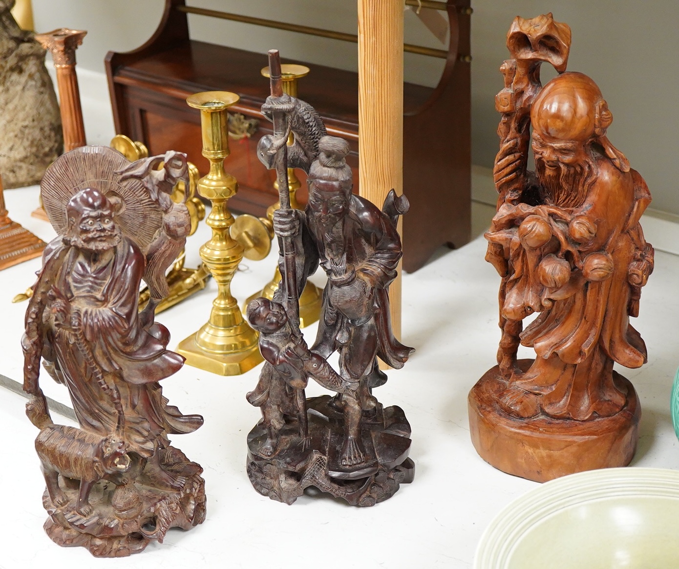 Three Chinese carved wood figures; Shou Lao, a fisherman and a Luohan, tallest 39cm